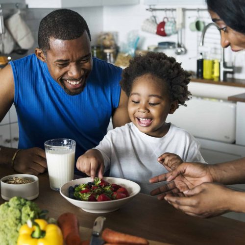 Black family eating healthy food together